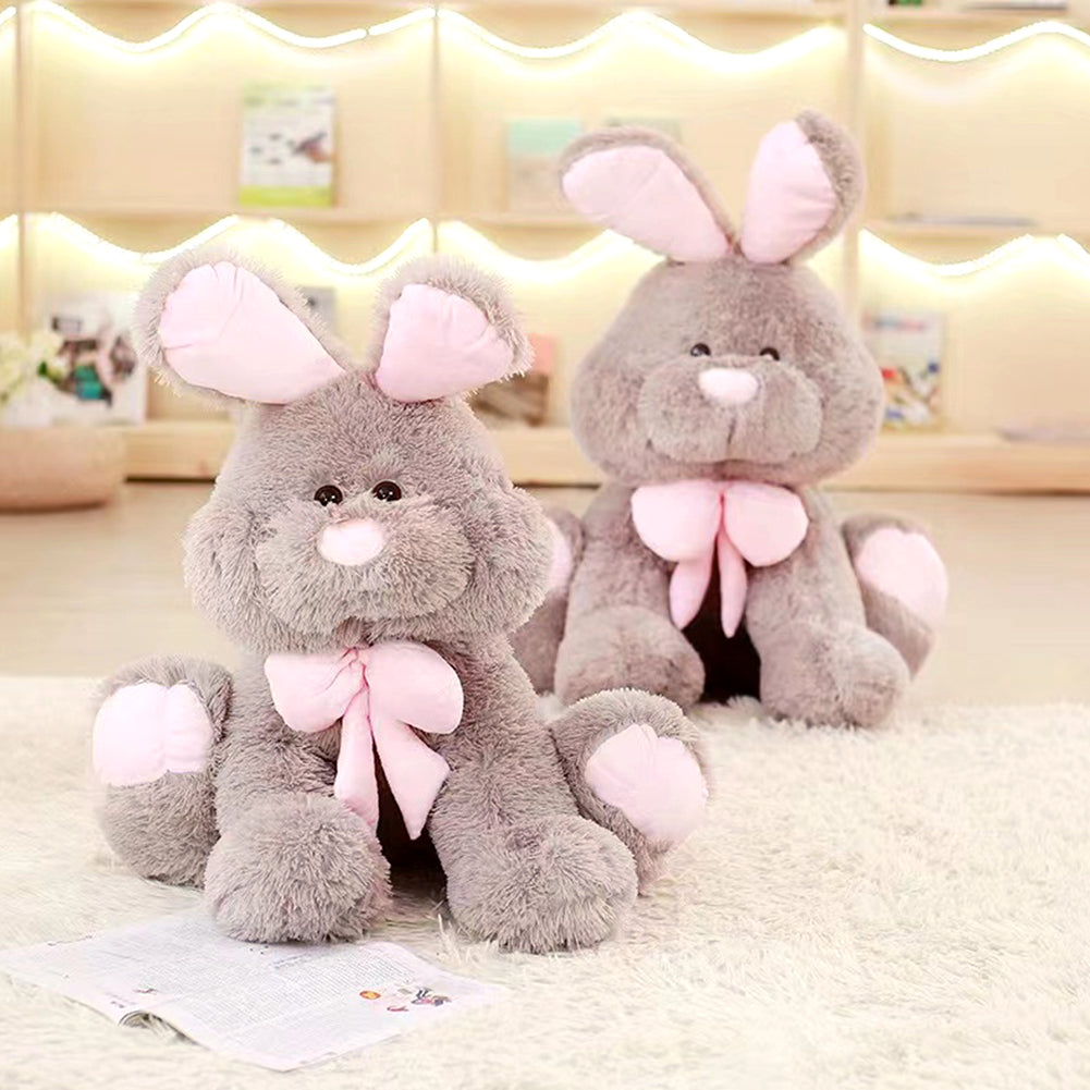 Two grey plush rabbit stuffed dolls with long pink ears and big bow ties